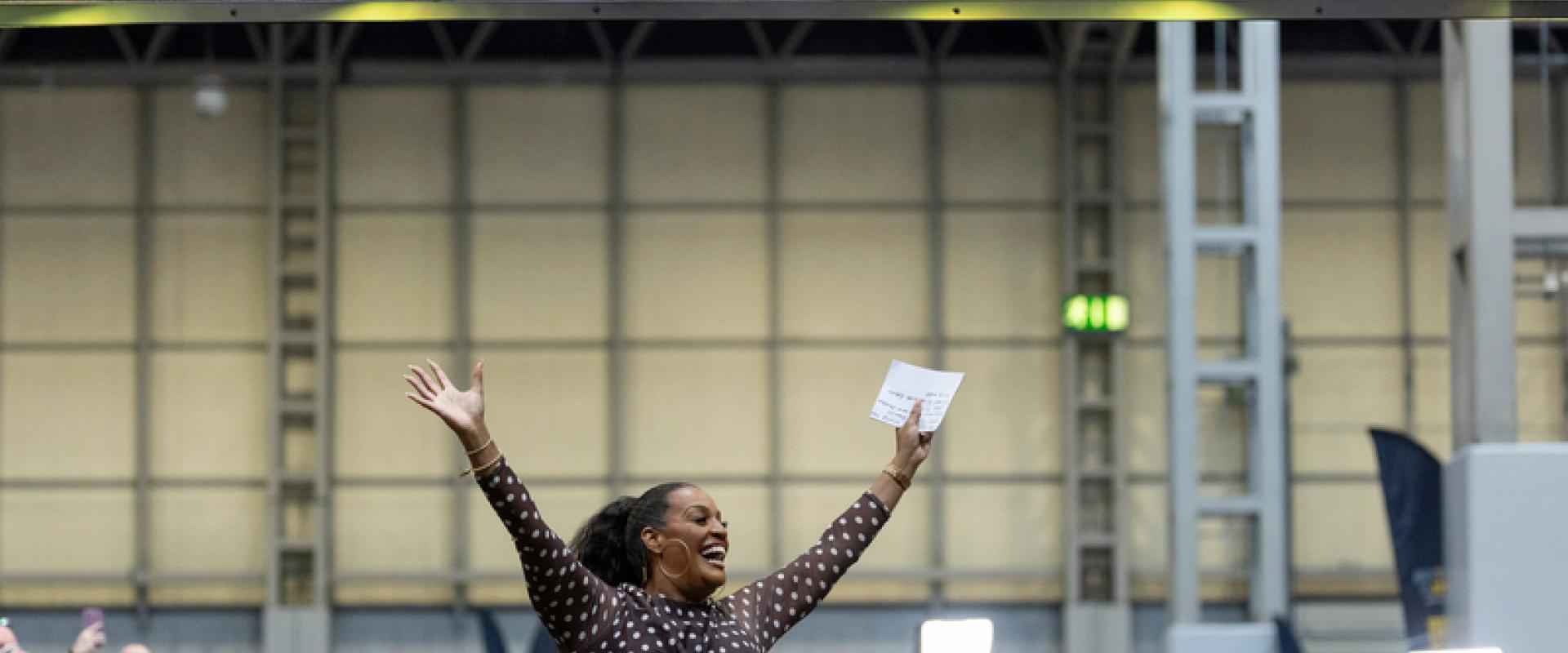 Alison hammonD in the NEC arms in the air.