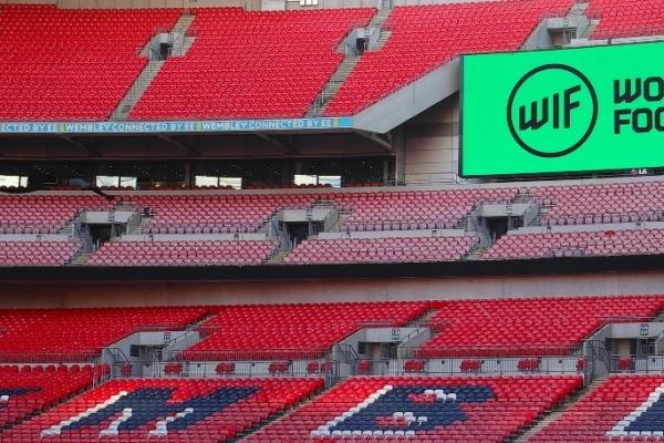 Women in Football branding on screen inside Wembley Stadium
